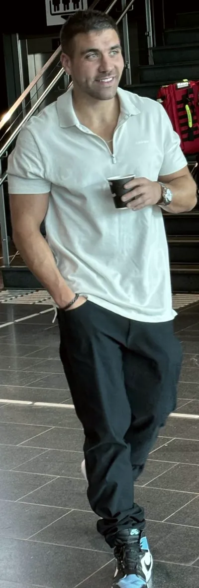 Paul walking through a venue lobby with a coffee in hand